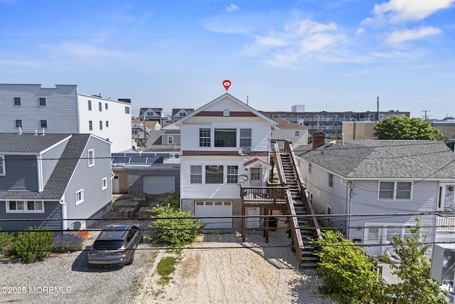 118 Sampson Ave, Seaside Heights, NJ 08751 - view of building exterior with driveway, an attached garage, stairway, and a residential view