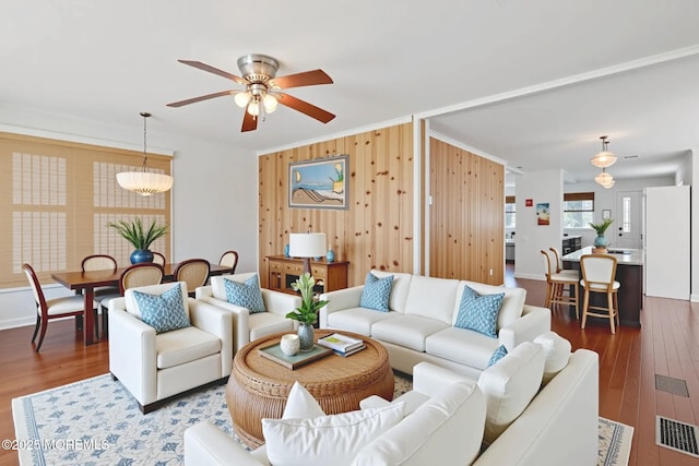 118 Sampson Ave, Seaside Heights, NJ 08751 - living area featuring a ceiling fan, dark wood-style floors, wooden walls, and crown molding