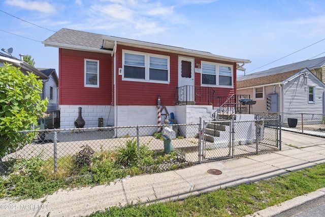 242 Sherman Ave, Seaside Heights, NJ 08751 - view of front of home featuring a fenced front yard, a gate, and roof with shingles