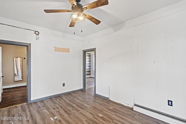242 Sherman Ave, Seaside Heights, NJ 08751 - spare room with baseboard heating, wood finished floors, and a ceiling fan