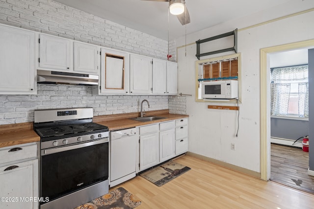 242 Sherman Ave, Seaside Heights, NJ 08751 - kitchen featuring white appliances, under cabinet range hood, wood counters, light wood-type flooring, and white cabinets