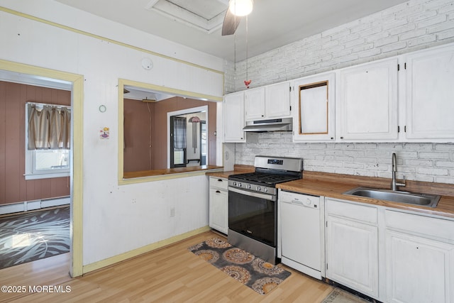 242 Sherman Ave, Seaside Heights, NJ 08751 - kitchen featuring white dishwasher, under cabinet range hood, stainless steel range with gas stovetop, light wood-type flooring, and white cabinets