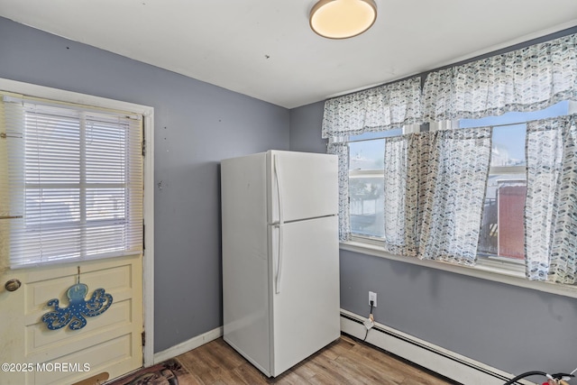 242 Sherman Ave, Seaside Heights, NJ 08751 - kitchen featuring freestanding refrigerator, a baseboard heating unit, and wood finished floors