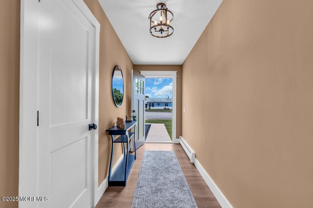 3 Andover Ct, Toms River, NJ 08757 - entryway with a baseboard radiator, a chandelier, and wood finished floors