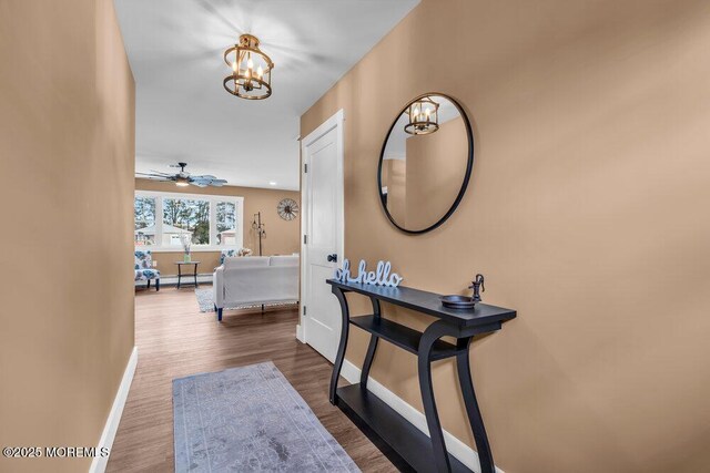 3 Andover Ct, Toms River, NJ 08757 - hallway with a chandelier, wood finished floors, and baseboard heating