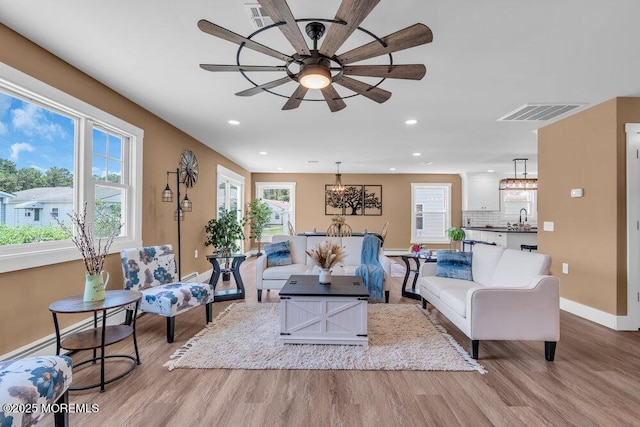 3 Andover Ct, Toms River, NJ 08757 - living room with wood finished floors, a chandelier, healthy amount of natural light, ceiling fan, and recessed lighting
