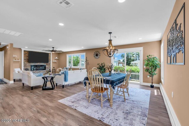 3 Andover Ct, Toms River, NJ 08757 - dining space with recessed lighting, wood finished floors, a ceiling fan, a fireplace, and a chandelier