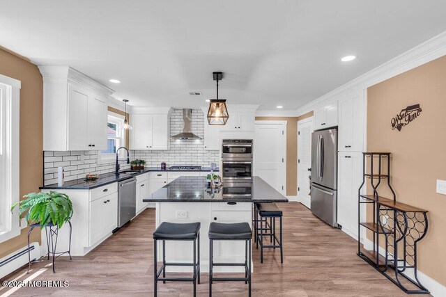 3 Andover Ct, Toms River, NJ 08757 - kitchen with stainless steel appliances, wall chimney exhaust hood, white cabinets, backsplash, and a breakfast bar area