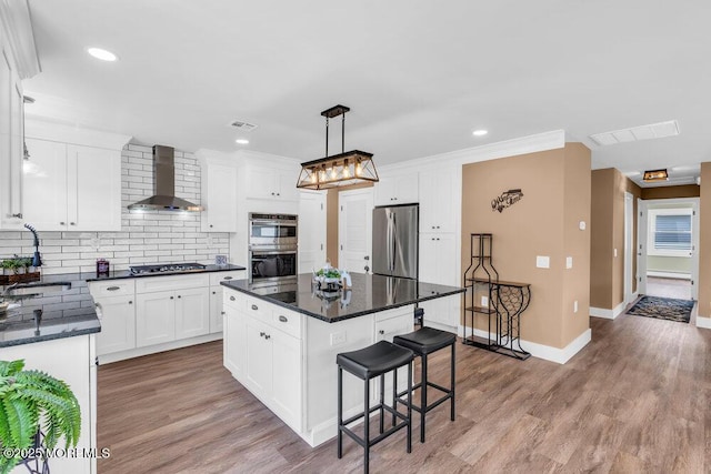 3 Andover Ct, Toms River, NJ 08757 - kitchen featuring wall chimney exhaust hood, appliances with stainless steel finishes, a breakfast bar area, tasteful backsplash, and a kitchen island
