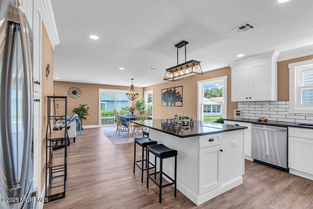 3 Andover Ct, Toms River, NJ 08757 - kitchen featuring stainless steel dishwasher, fridge, dark countertops, recessed lighting, and a breakfast bar area