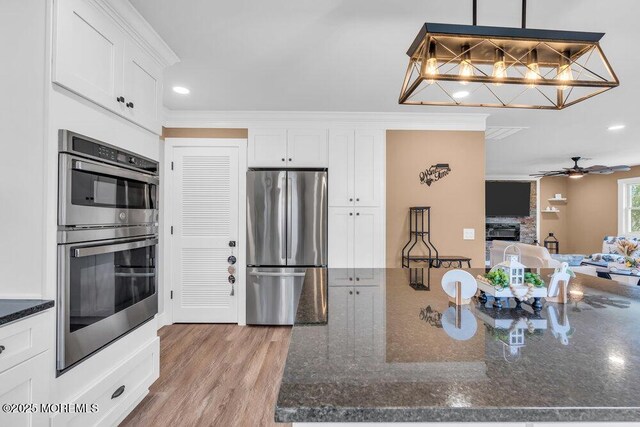 3 Andover Ct, Toms River, NJ 08757 - kitchen with stainless steel appliances, white cabinets, recessed lighting, dark stone countertops, and ornamental molding