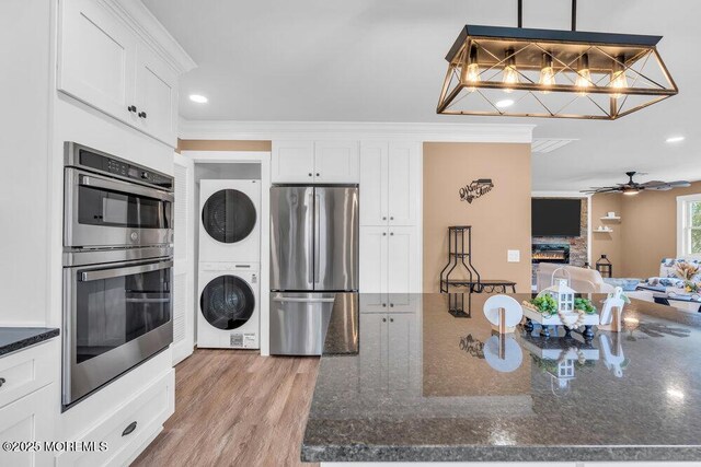 3 Andover Ct, Toms River, NJ 08757 - kitchen with appliances with stainless steel finishes, estacked washer and dryer, white cabinetry, dark stone counters, and recessed lighting