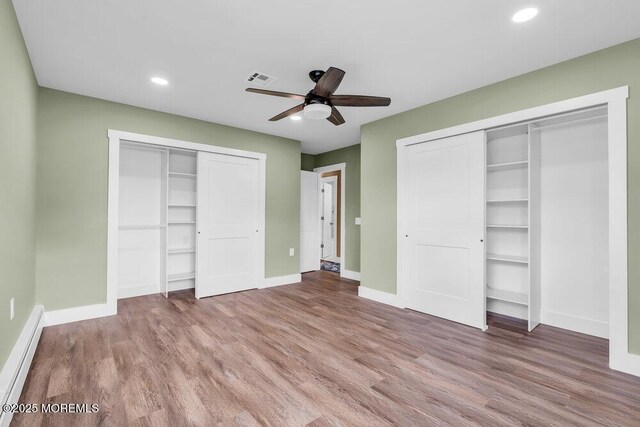 3 Andover Ct, Toms River, NJ 08757 - unfurnished bedroom featuring two closets, baseboard heating, wood finished floors, recessed lighting, and ceiling fan