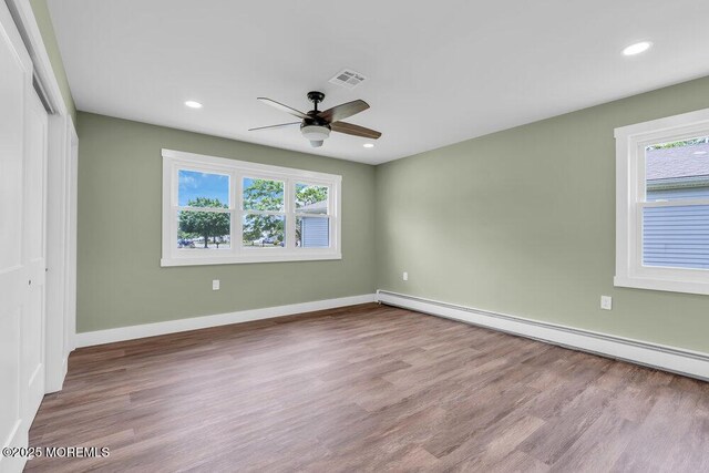 3 Andover Ct, Toms River, NJ 08757 - unfurnished bedroom with baseboard heating, multiple windows, wood finished floors, and recessed lighting