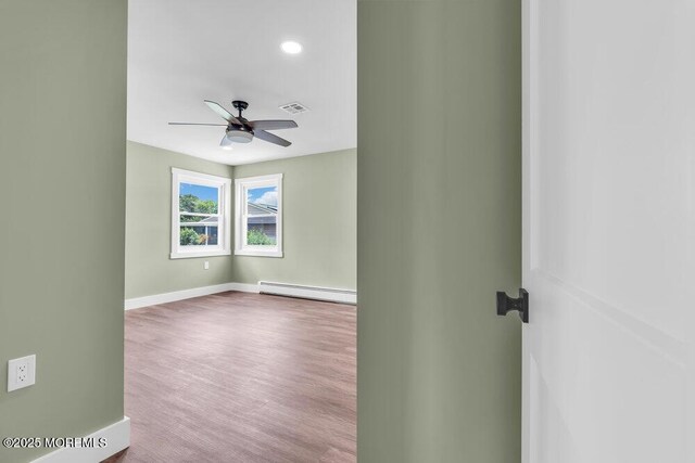3 Andover Ct, Toms River, NJ 08757 - spare room featuring a baseboard radiator, wood finished floors, and ceiling fan