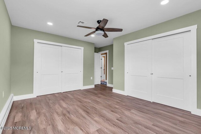 3 Andover Ct, Toms River, NJ 08757 - unfurnished bedroom featuring multiple closets, recessed lighting, baseboard heating, wood finished floors, and ceiling fan