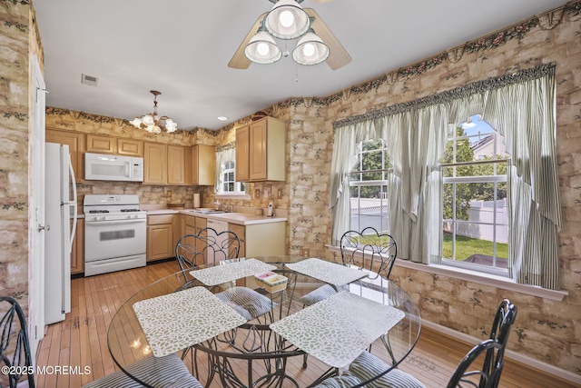 28 Brent Dr, Howell, NJ 07731 - dining area with plenty of natural light, a chandelier, a ceiling fan, and light wood-style floors