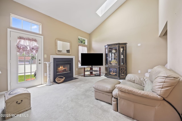 28 Brent Dr, Howell, NJ 07731 - carpeted living room with a skylight, high vaulted ceiling, and a fireplace with flush hearth