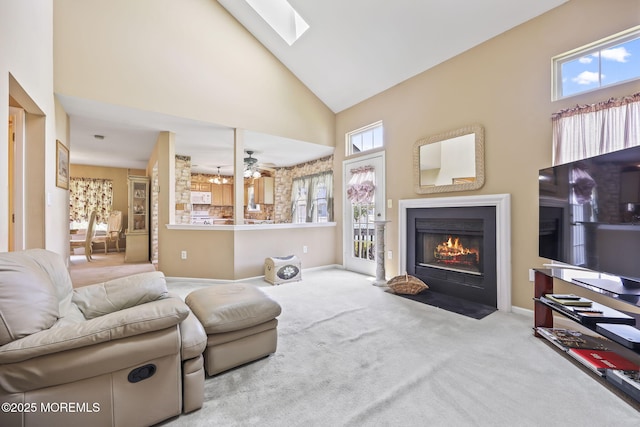 28 Brent Dr, Howell, NJ 07731 - carpeted living area featuring high vaulted ceiling, a fireplace with flush hearth, a skylight, and a ceiling fan