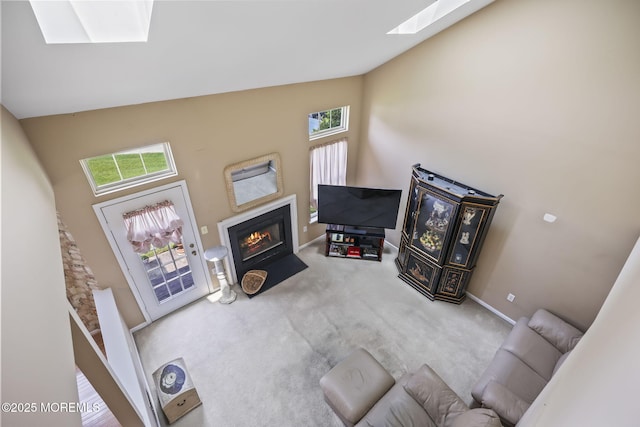 28 Brent Dr, Howell, NJ 07731 - living room with a skylight, a fireplace with flush hearth, carpet flooring, and high vaulted ceiling