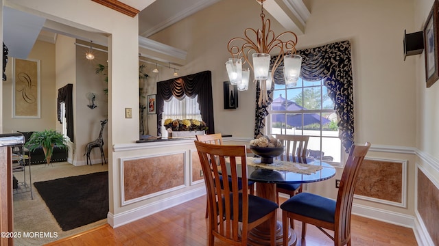44 Kentucky Way, Freehold, NJ 07728 - dining area with a chandelier, healthy amount of natural light, wood finished floors, crown molding, and vaulted ceiling