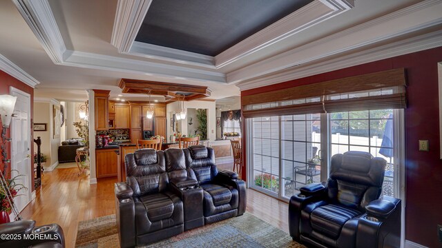 44 Kentucky Way, Freehold, NJ 07728 - living room with a raised ceiling, ornate columns, light wood-style flooring, and ornamental molding