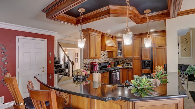 44 Kentucky Way, Freehold, NJ 07728 - kitchen with black range with gas stovetop, premium range hood, brown cabinets, backsplash, and dark countertops