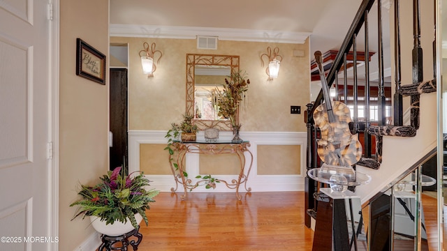 44 Kentucky Way, Freehold, NJ 07728 - entryway with wood finished floors, a wainscoted wall, stairs, and ornamental molding