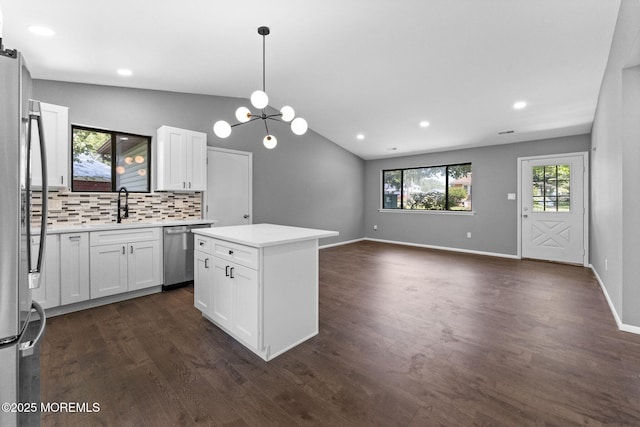 112 Beacon St, Moorestown, NJ 08057 - kitchen featuring stainless steel appliances, backsplash, light countertops, white cabinets, and dark wood finished floors