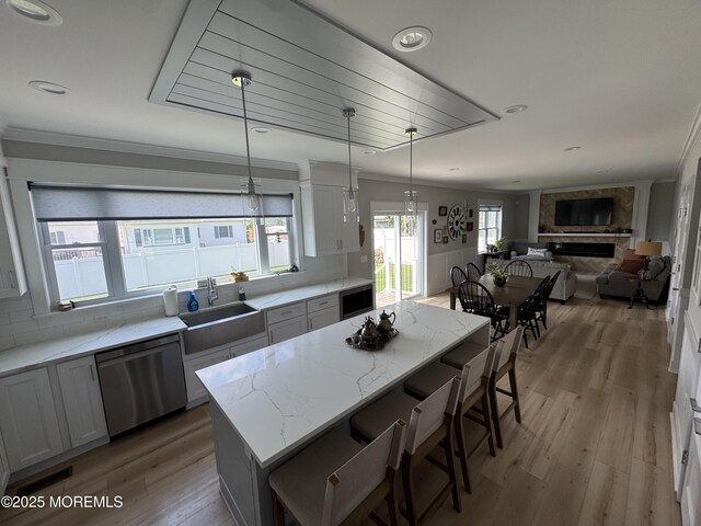 1464 Earie Way, Forked River, NJ 08731 - kitchen featuring dishwasher, light stone counters, light wood-style floors, a kitchen island, and a breakfast bar