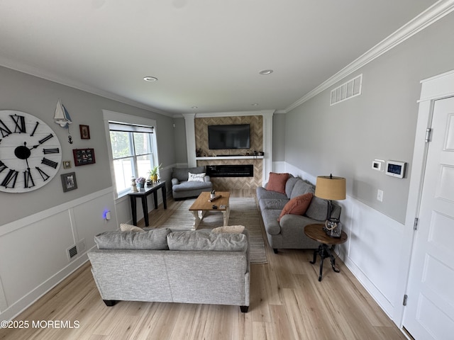 1464 Earie Way, Forked River, NJ 08731 - living room with light wood-type flooring, crown molding, a fireplace, and a wainscoted wall