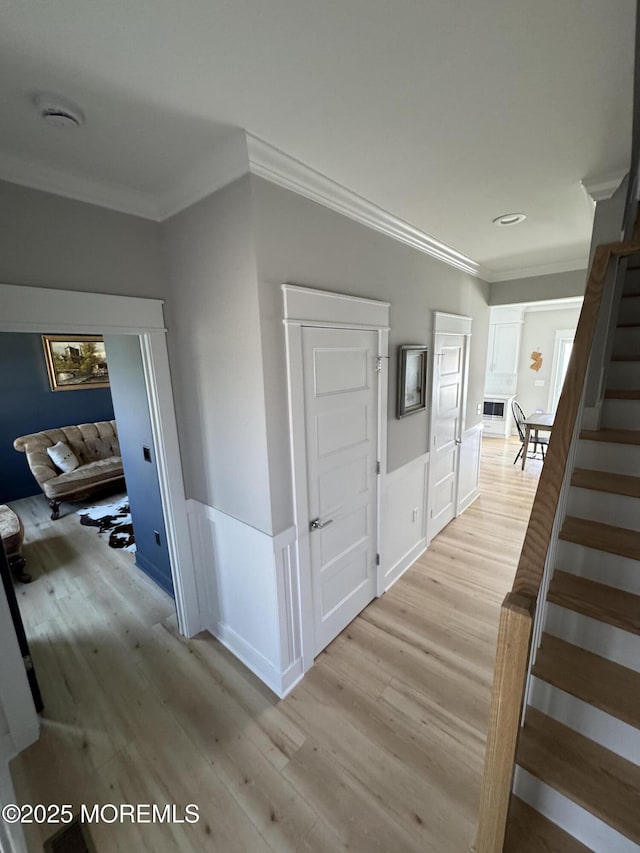 1464 Earie Way, Forked River, NJ 08731 - corridor with light wood-style flooring, ornamental molding, stairs, and a wainscoted wall