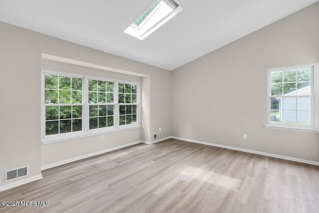 63 Oak Ln, Eatontown, NJ 07724 - unfurnished room featuring light wood-type flooring, lofted ceiling, and a skylight