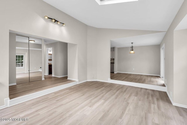 63 Oak Ln, Eatontown, NJ 07724 - unfurnished living room with light wood finished floors and high vaulted ceiling