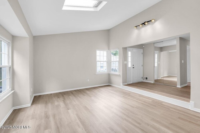 63 Oak Ln, Eatontown, NJ 07724 - spare room with vaulted ceiling, light wood-style floors, and a skylight