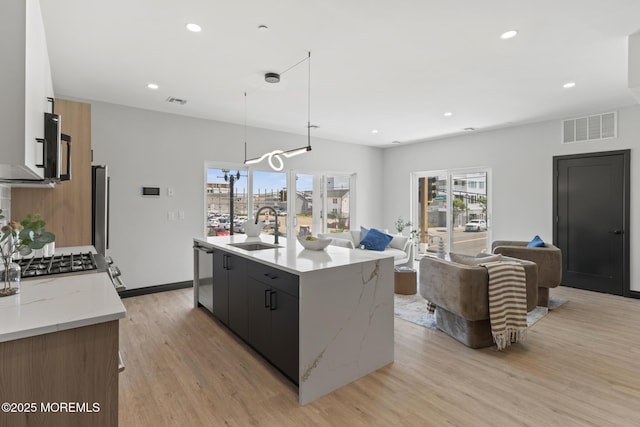 401 Boulevard 202, Seaside Heights, NJ 08751 - kitchen featuring light wood-type flooring, a kitchen island with sink, stainless steel dishwasher, open floor plan, and recessed lighting