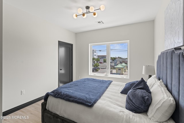 401 Boulevard 202, Seaside Heights, NJ 08751 - bedroom with a chandelier and light wood-type flooring