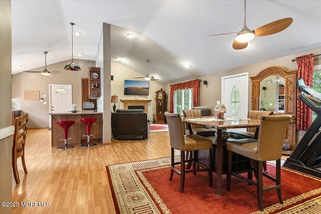 444 Cook Rd, Jackson, NJ 08527 - dining room featuring a ceiling fan, lofted ceiling, a fireplace, and light wood-style floors