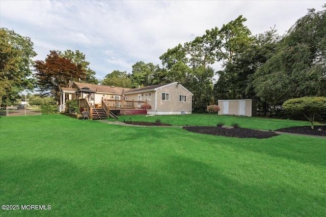 444 Cook Rd, Jackson, NJ 08527 - view of grassy yard with a deck and a storage shed