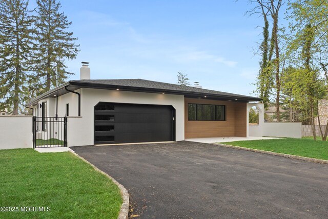441 Slocum Pl, Oakhurst, NJ 07755 - modern home featuring an attached garage, asphalt driveway, a chimney, a gate, and stucco siding