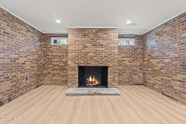 441 Slocum Pl, Oakhurst, NJ 07755 - unfurnished living room featuring brick wall, wood finished floors, and a fireplace