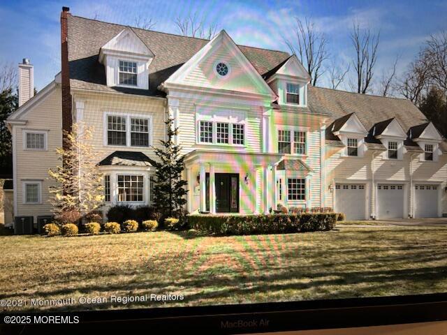 41 Marlpit Pl, Middletown, NJ 07748 - view of front of home with a chimney, a front yard, and a garage