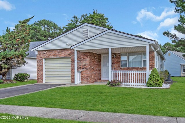 46 Carmacks Way, Toms River, NJ 08757 - view of front facade with an attached garage, brick siding, a porch, and driveway