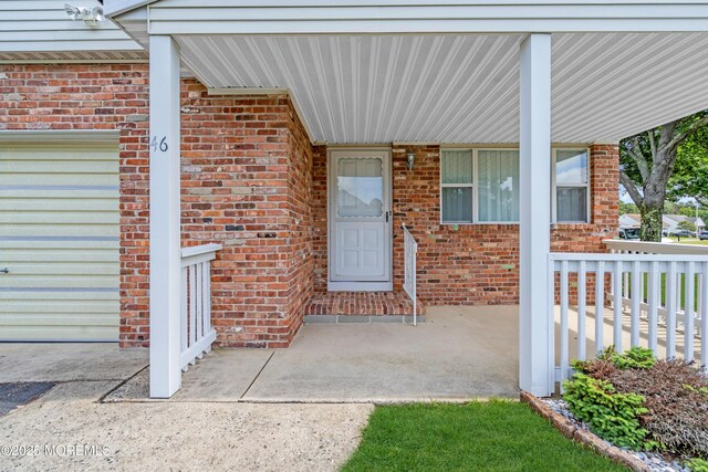 46 Carmacks Way, Toms River, NJ 08757 - view of exterior entry with brick siding and a porch