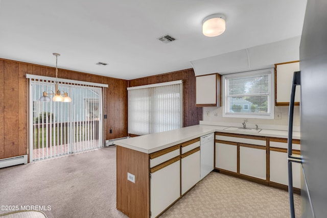 46 Carmacks Way, Toms River, NJ 08757 - kitchen featuring light countertops, wooden walls, a peninsula, dishwasher, and white cabinetry