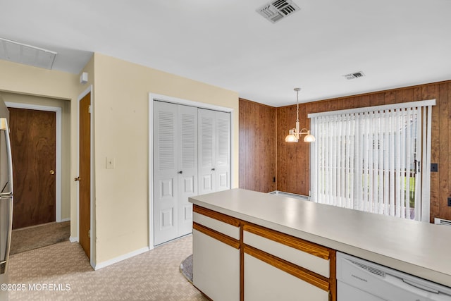 46 Carmacks Way, Toms River, NJ 08757 - kitchen featuring dishwasher, wooden walls, light countertops, pendant lighting, and light carpet