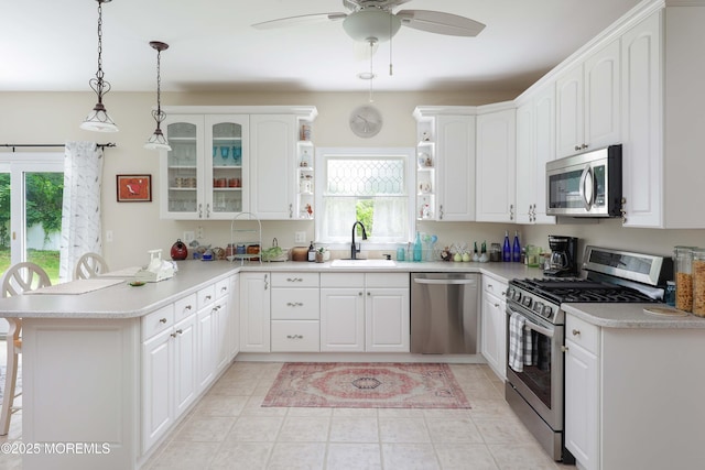 8001/2 Schoolhouse Rd, Brielle, NJ 08730 - kitchen with stainless steel appliances, open shelves, a peninsula, ceiling fan, and decorative light fixtures