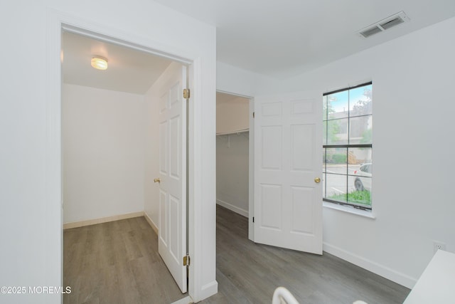 402 Hidden Village Dr Unit 402, Perth Amboy, NJ 08862 - unfurnished bedroom with wood finished floors, a walk in closet, and a closet