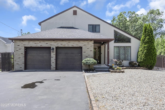 993 Sandy Cir, Manahawkin, NJ 08050 - view of front of house with brick siding, asphalt driveway, a garage, and roof with shingles