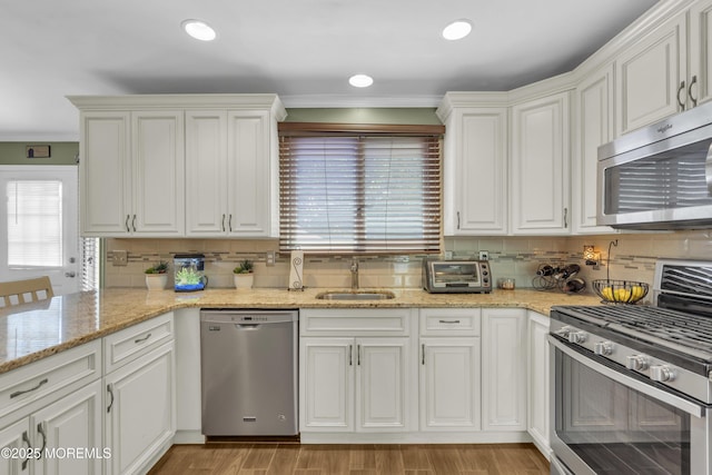 993 Sandy Cir, Manahawkin, NJ 08050 - kitchen featuring stainless steel appliances, tasteful backsplash, white cabinetry, light stone counters, and crown molding